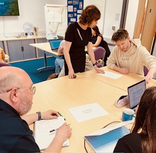  Gillian working with course members in a classroom environment